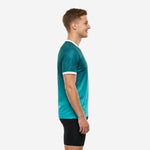 Custom teal soccer training jersey left side view showing gradient teal-to-aqua fabric and white sleeve cuff trim on male model