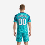 Full-dye sublimated teal soccer uniform kits for men showing hex pattern detail on jersey front and shorts
