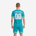 Close detail of geometric triangle band on custom teal soccer team uniform set with white contrast crew neck trim