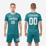 Full body view of custom teal and white soccer uniform set worn by male model showing complete two-piece kit design