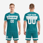 Full body view of custom teal and white soccer uniform set with sublimated print detail