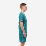 Custom teal soccer uniforms left side view displaying full sublimated arc design on jersey and diagonal line shorts