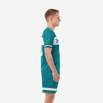 Custom teal soccer uniform side view showing white double-stripe sleeve cuffs and shorts hem
