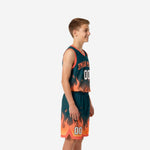 Front view of custom teal youth basketball uniforms showing orange flame graphic rising from jersey hem and shorts legs with player number 00