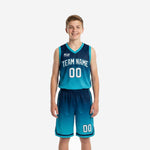 Custom teal youth basketball uniforms showing navy-to-teal gradient jersey and matching shorts, front and back view, with arched team name and player numbers