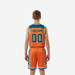 Side view of custom teal youth basketball uniforms showing diagonal-stripe teal side panels on jersey and shorts with white hem binding