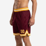 Custom team basketball shorts maroon and gold back view showing full-dye sublimation finish and chevron hem stripe from rear