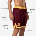 Custom team basketball shorts in maroon and gold with chevron hem stripe, sublimated player number 00 on front leg, elastic gold and white waistband