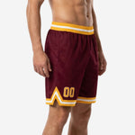 Custom team basketball shorts maroon and gold left side view showing side panel construction and hem stripe detail