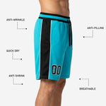 Back view of custom team basketball shorts in teal and black showing the full side panel, hem finish, and elastic waistband