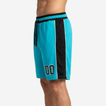 Close detail of the black side panel and white pinstripe trim on custom team basketball shorts in teal showing the edge finish at mid-thigh
