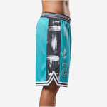 Side view of custom team basketball shorts showing full-length black side panel with white and teal brush-stroke splash pattern