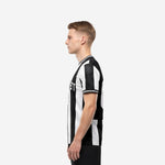 Custom team soccer jersey black and white vertical stripe, right side view displaying full-dye sublimation print and crew neckline on male model