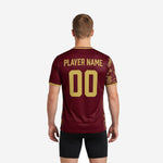 Club training jersey in maroon with athletic gold crew neck trim and camo sleeve detail close-up