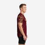 Custom training jerseys for teams showing athletic gold digital camo pattern on left sleeve, side view