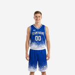 Custom travel basketball uniforms in royal blue and white pixel-scatter sublimation, front and back view of full two-piece set