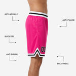 Close detail of white-and-black V-notch chevron hem trim on custom pink team basketball shorts with player number placement