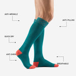 Custom turquoise soccer socks showing coral reinforced toe block and teal calf panel, full-dye sublimation colorfast print