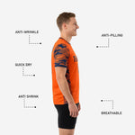 Orange and navy camo soccer training jersey sleeve detail showing edge to edge sublimation print across seam