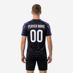 Custom two tone training jersey sleeve detail showing full cyan and purple lightning bolt sublimation from shoulder seam to cuff trim