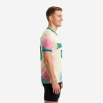 Custom two tone training jersey side view left showing teal V-neck collar and cream base with watercolor splash design