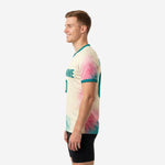 Custom two tone training jersey side view right showing back number placement and teal sleeve cuff trim on cream base