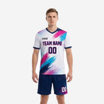 Custom unique soccer uniforms in white with hot pink and sky blue brush-stroke print and navy shorts, front view on male model