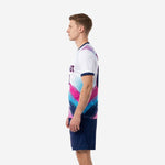 Custom unique soccer uniforms displaying layered brushstroke sublimation print on white base with navy shorts, right side view