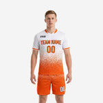 Men's custom unique soccer uniforms in white-to-orange dot-burst gradient, front view showing team name and number on jersey with matching orange shorts