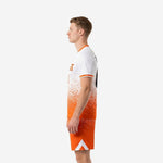 Right-side profile of custom unique soccer uniforms in orange and white with white chevron hem detail on the shorts and V-neck collar trim