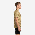 Side view of custom Vegas Gold mens custom training jersey showing chocolate brown sleeve cuff trim and wave pattern