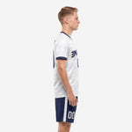 Custom white camo soccer jersey with navy blue shorts, white side stripe, side view on male model