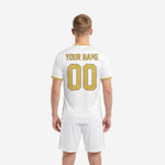 Custom soccer uniform design in white with athletic gold accents, V-neck jersey and matching shorts