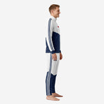 Custom white soccer tracksuit with navy blue diagonal panel and three-stripe sleeve detail, left side view on male model