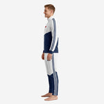 Men's custom white and navy soccer tracksuit showing tapered pant leg colorblock and stripe detail, right side view