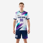 Custom white soccer uniforms with purple and teal brush-stroke print, front view, men's full kit including navy blue shorts
