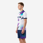 Men's white soccer uniform side view right showing purple brush-stroke design and navy blue sublimated shorts with teal fade