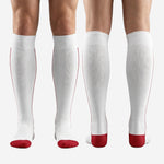Custom white and red soccer socks full-length pair showing over-the-calf coverage for shin guard wear
