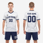 Custom white soccer uniforms full kit back view showing navy blue shorts with white side stripe and player number