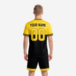 Custom yellow and black soccer jersey front detail with team name in yellow chest zone and player number on black lower body