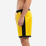 Custom yellow soccer shorts with black contrast side panel and straight black hem, left side view on adult male model