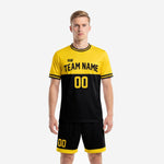 Custom yellow soccer uniform front view showing yellow and black colorblock jersey with black shorts on adult male model