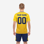 Custom yellow soccer jersey front detail showing hex pattern sublimation, team name, and number print zones