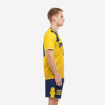 Custom yellow and navy soccer uniform set side view showing hex texture pattern on athletic gold jersey