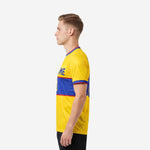Custom yellow soccer jersey with Royal Blue band and Crimson stripe cuff trim, right side view on adult male model