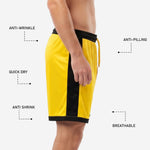 Black side panel detail on custom yellow and black soccer shorts showing full-length contrast trim