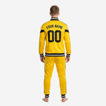 Close-up of custom yellow soccer tracksuit jacket chest showing team logo placement above black chevron V-panel