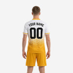 Athletic Gold and White custom soccer jersey detail showing dot-burst sublimation print and V-neck collar with gold trim