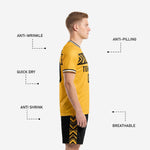 Black soccer shorts detail from custom yellow soccer uniform set showing sublimated gold chevron side panels and elastic drawcord waistband