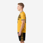Men's custom yellow soccer uniform right side view displaying full-dye sublimated Athletic Gold jersey and black shorts with gold geometric trim